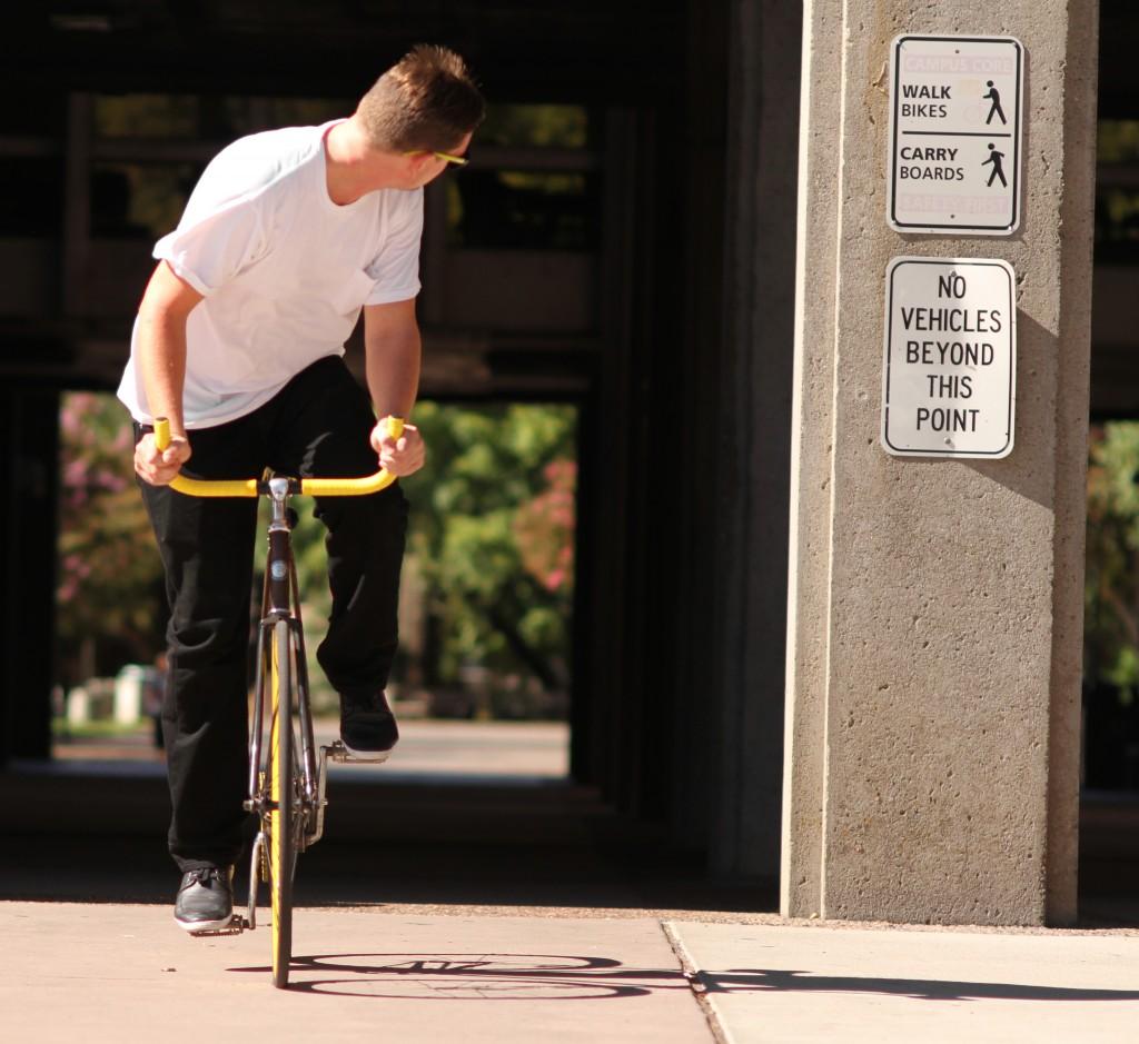 Riley Mundia Dustin Stene, a 23-year-old recreation major, rides his bike home through campus.