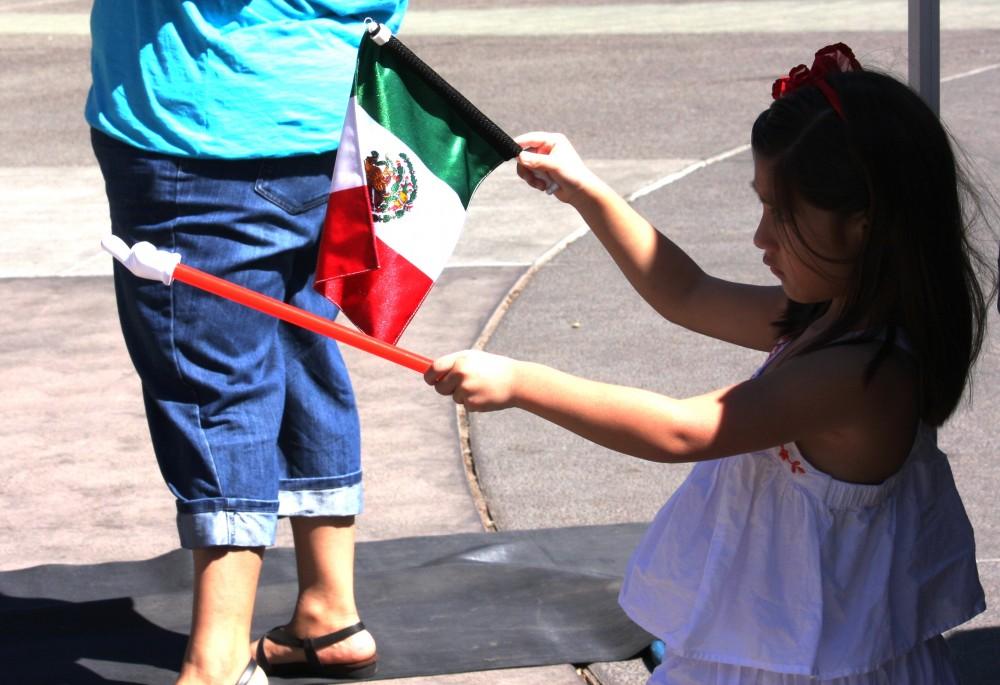 Shelby Keck
Five-year-old Azul Vazquez waves Mexicos flag as the Mexican National Anthem is sung during the Mexican Independence Day celebration in Chico City Plaza on Sunday.