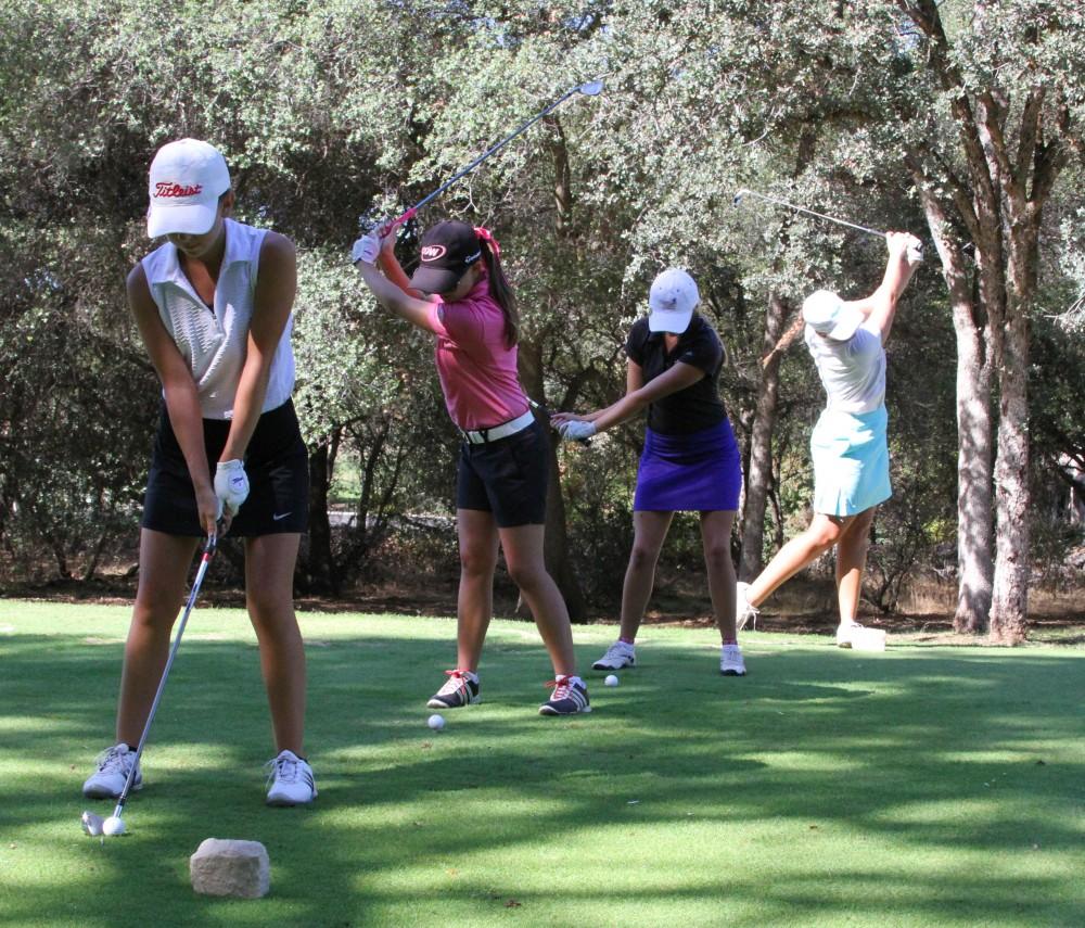 File photo by Riley Mundia
Chico State womens golfers Abbey McGrew, Dani OKeefe, Sydney Zink and Sarah McComish take some practice swings on the tee box.
