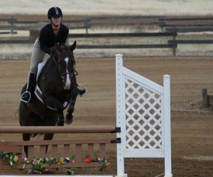Photograph by Shelby Keck Brittany Craker, a junior pre-veterinary student, jumps her horse, Dexter, over an obstacle Sunday during the 2013 Hunter Jumper Series competition held at Camelot Equestrian Park in Oroville.