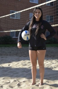 Photograph by Dan Reidel Freshman setter Torey Thompson poses on a beach volleyball court in front of Lassen Hall.