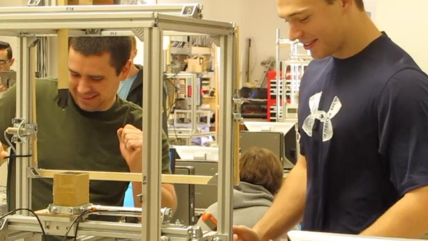 Mechanical engineering majors Trevor Borelli and Forrest Clune are working on an electric machine in their engineering class. The machine they named as 