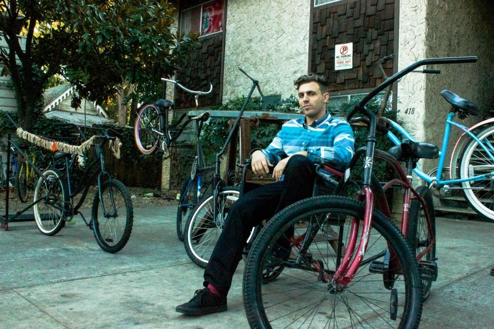 Travis Stock, senior art major, sitting in one of his many revolutionary bikes.Photo credit: Chelsea Jeffers