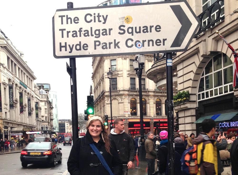 Writer Michelle Manera travels to London for the first time and poses for a picture at Piccadilly Circus.