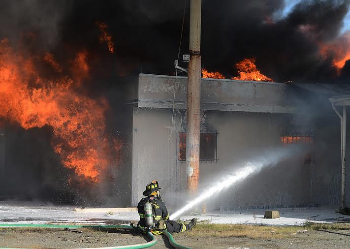 Campbell attends to a fire with a high-pressure hose. Photo Courtesy of Jesse Campbell.