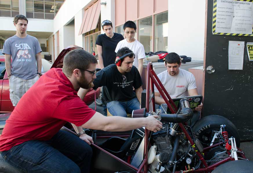 Members of the Formula Society of Automotive Engineers at Chico State run tests on the vehicle so that it can idle consistently. Photo credit: Nicholas Carr