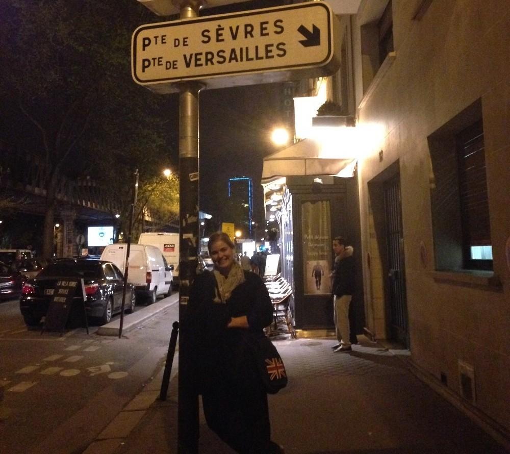 Michelle Manera poses next to a street sign in Paris. Photo courtesy of Michelle Manera.