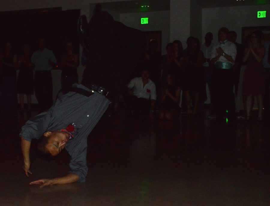 A break dancer backflips to victory at PETEs annual prom night while the audience watches. Photo credit: Veronica Hodur