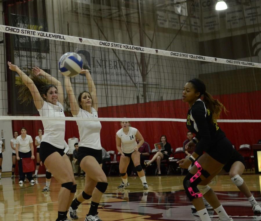 Freshman middle hitter Natalie Nordahl, left, and junior middle hitter Kristyn Casalino block a shot by the Lumberjacks last season. Chico State beat Cal State East Bay on Friday. Orion File Photo.