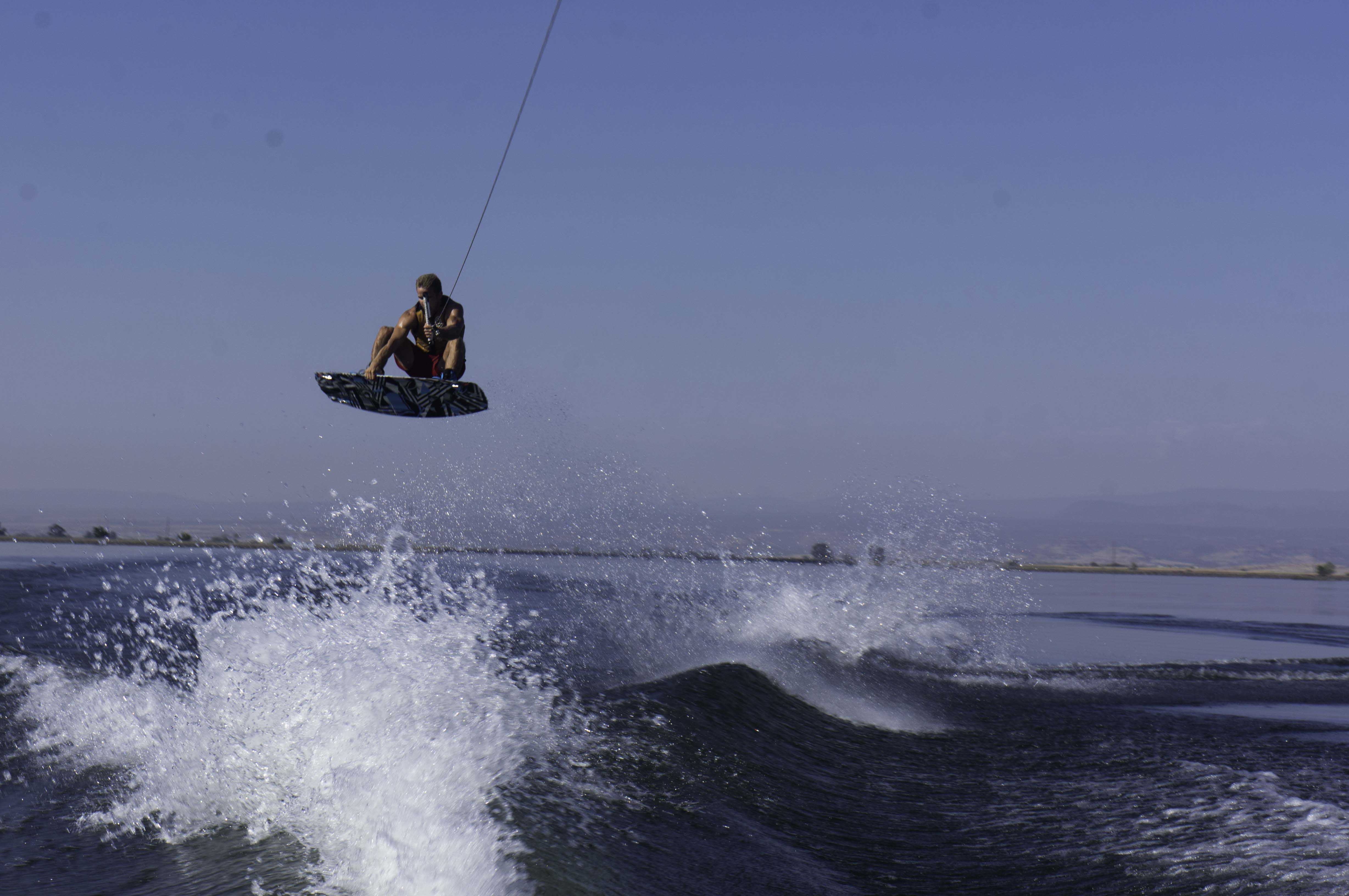 Chico State wakeboarder Colton Duncan sails through the air and over the wake in practice. Photo credit: Brandon Foster