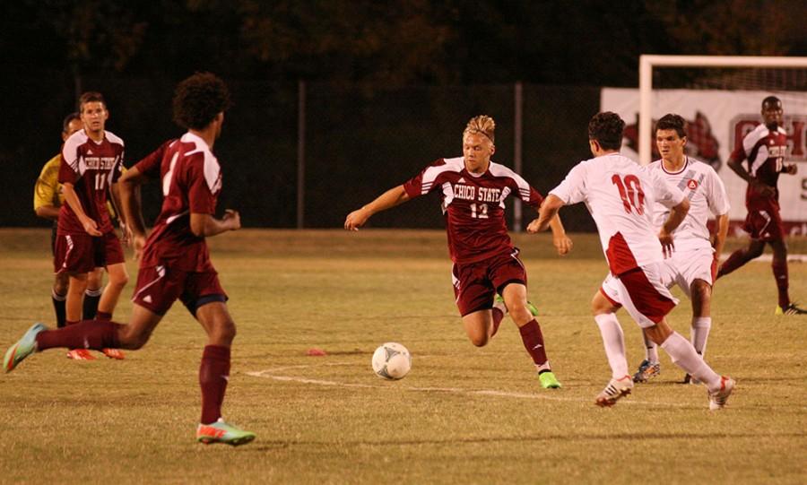 Freshman Carter Johnson weaves through opponents in a game earlier this year. Chico State scored twice in the second half to beat Holy Names 2-1 on Saturday. Photo credit: John Domogma