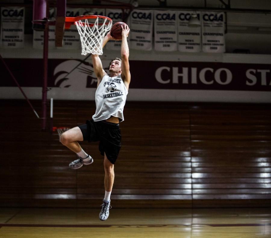 New Chico State basketball player Tanner Giddings practices dunking the ball at the Acker Gym. Photo credit: Emily Teague