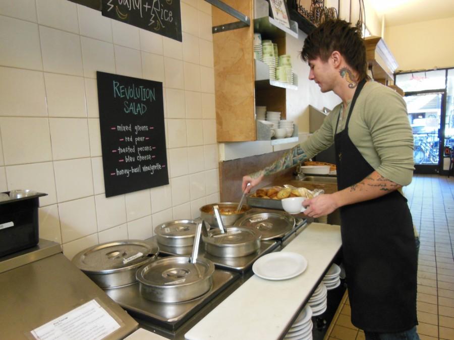 Alexander Madrid, a server at Upper Crust Bakery, pours some soup for a customer. Photo credit: Christina Saschin