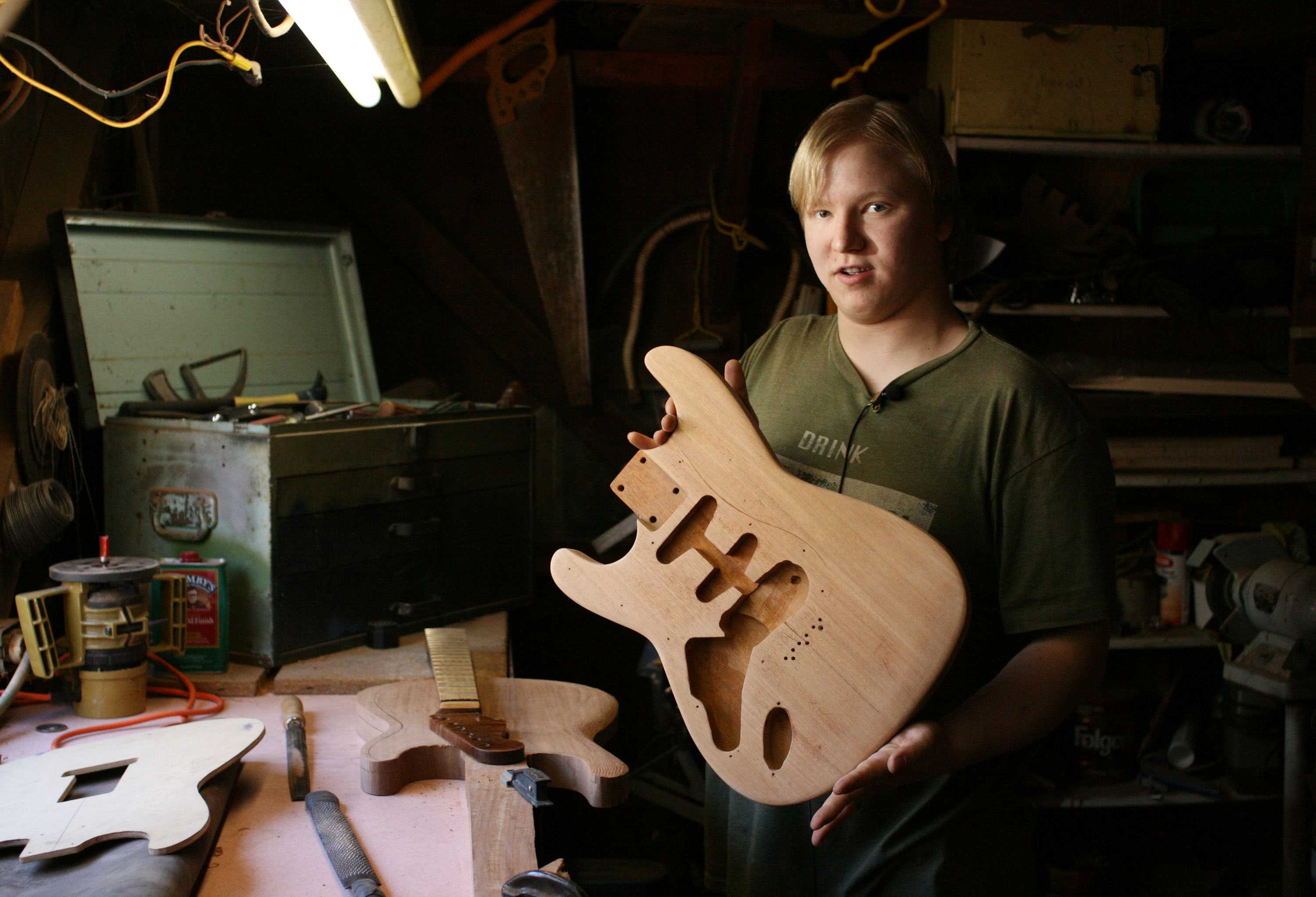 Evan Kelsay, 22, presents one of the unique pieces he's created at his workshop in Paradise. Kelsay is the owner and operator of Apocalypse Guitars, a custom-guitar building and repairing service. Photo credit: John Domogma
