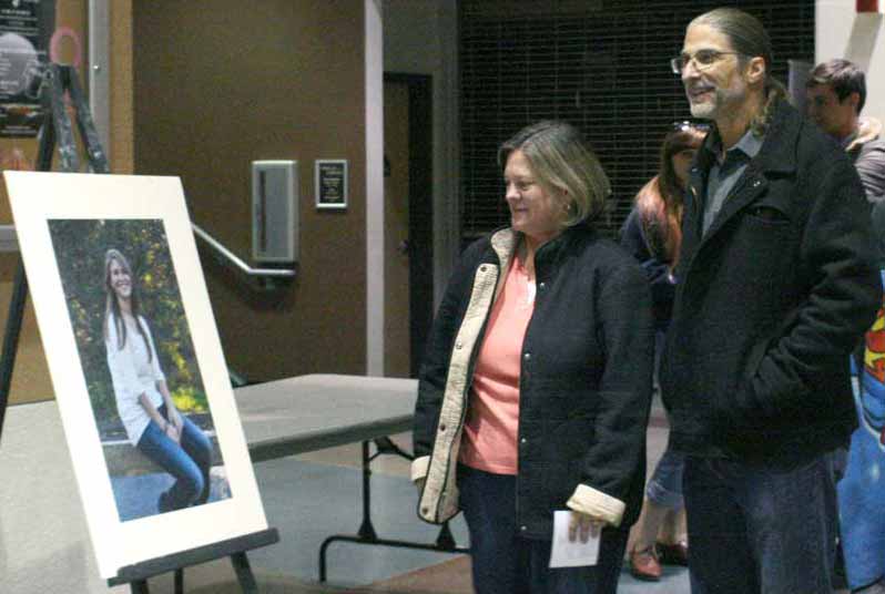 Mark and Patti Lewis at the Chico State Bell Memorial Union hall, Sept. 27, for a photo signing event dedicated to their deceased daughter, former student Samantha Lewis. Friends and family wrote messages to Lewis on the picture frames. Photo credit: John Domogma