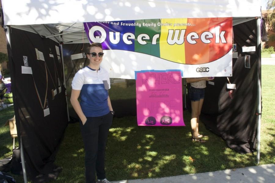 Taylor Holmes, junior women studies major, helps work the Queer Week table at the informational tabling fair.