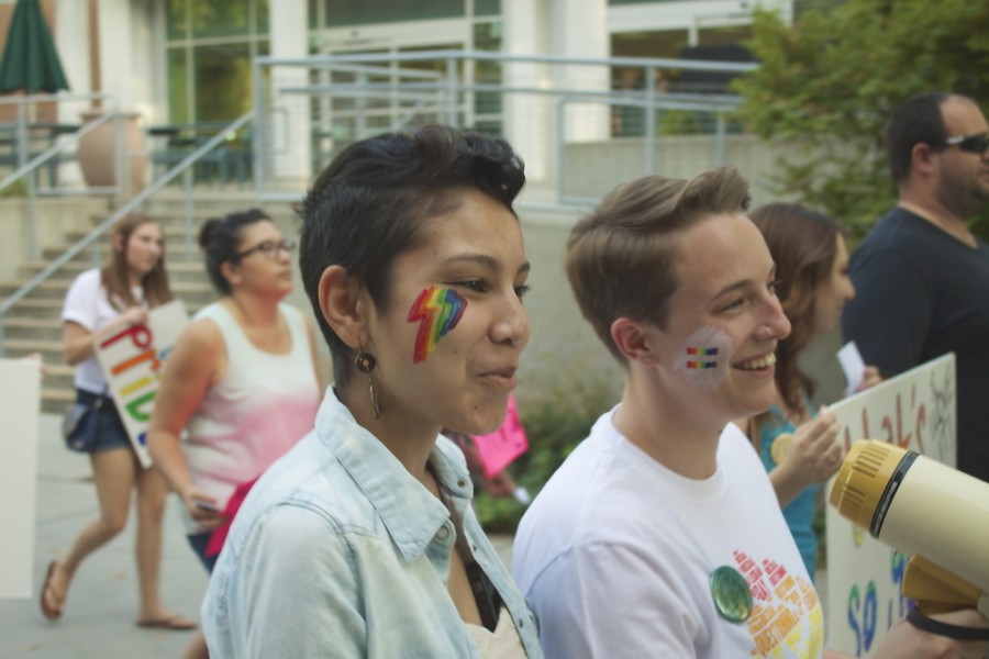 Analicia Hawkins and Taylor Holmes lead the chats during the Pride March. 