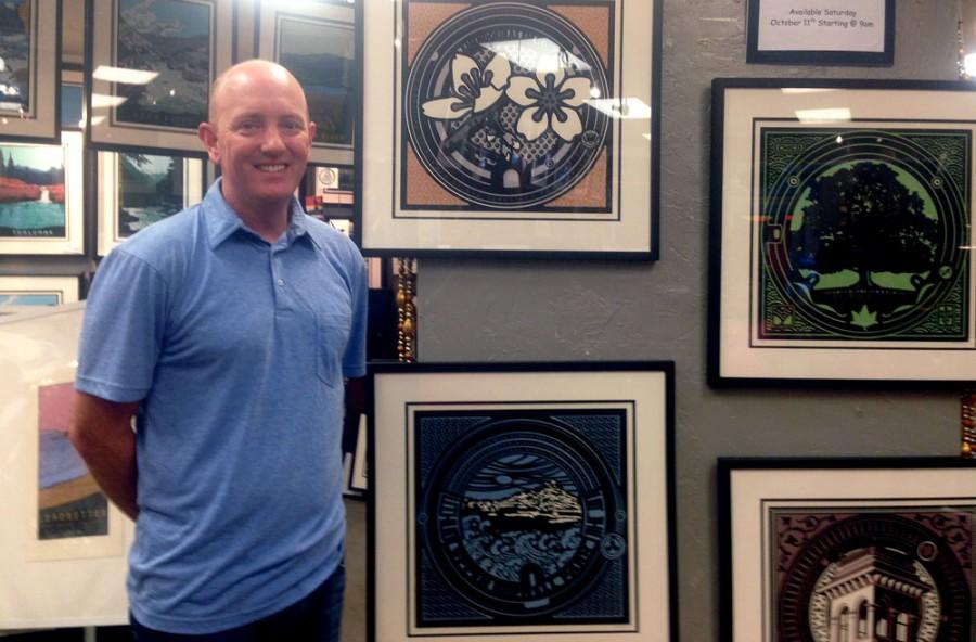 Chico State alumnus Jake Early stands next to some of the prints he created for his 'My Hometown