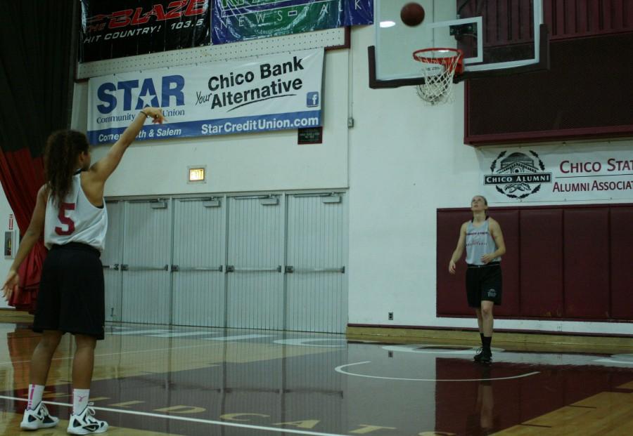 Hannah Womack is sharpening her free throw skills during practice while a teammate looks on. Photo credit: John Domogma