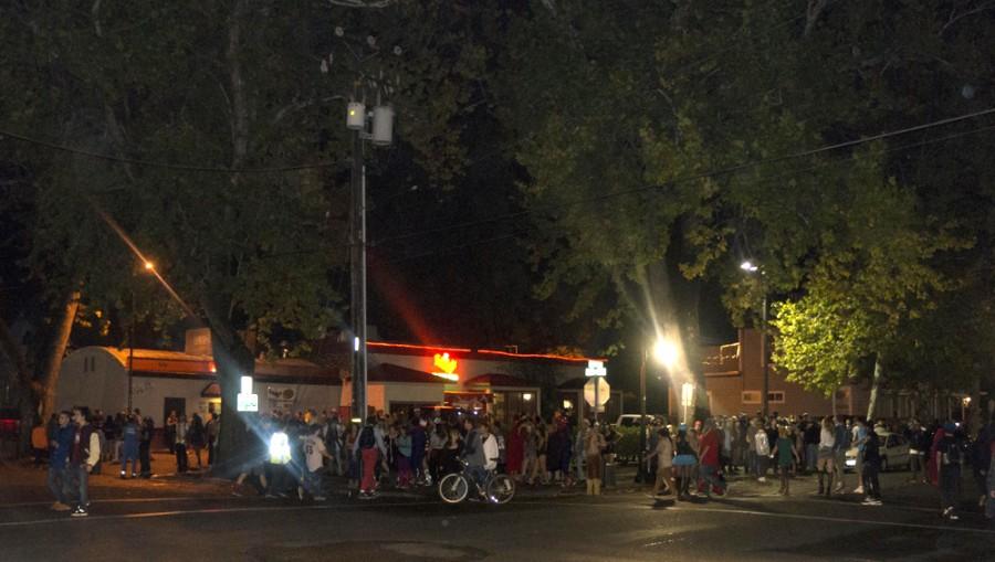 Uninhibited by the threat of gang violence and the early closing hours of Chico bars this Halloween weekend, tons of people take to the streets on friday night in celebration. Photo by Brandon Foster. 