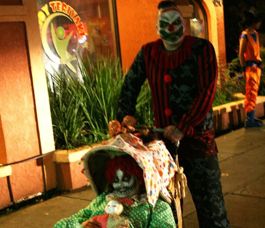 Adam Berry and Jessica Garland, locals of Chico take to the streets in their killer clown costumes on Halloween night 2014. Photo by John Domogma. 