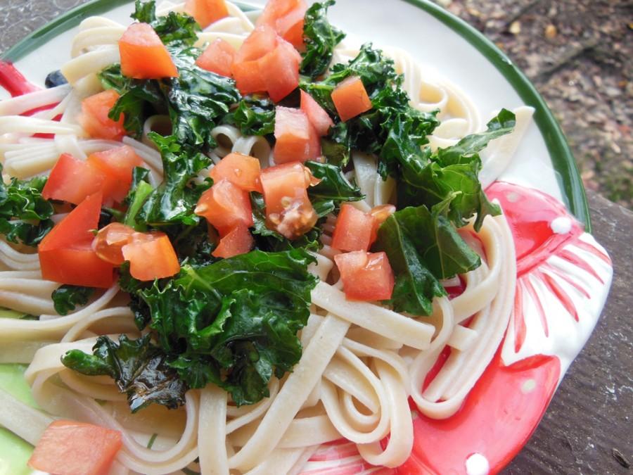 A holiday pasta dish with kale and tomato. Photo credit: Christina Saschin