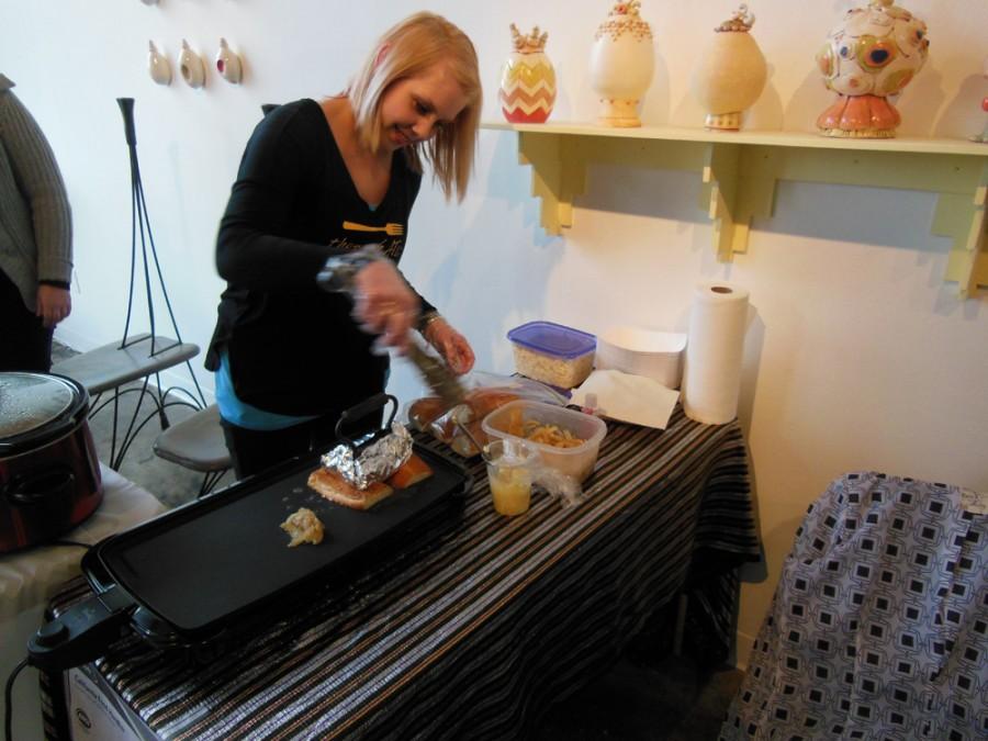 Molly Rzepecki makes pulled pork sandwiches at 1078 Gallery for its December Mixed Media Mixer event Sunday. Photo credit: Christina Saschin