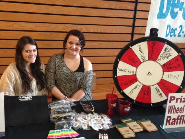 Diana Hass (left) and Athena Oreck, both senior recreation, hospitality and parks management majors, man the prize wheel on the last day of De-Stress Fest. Photo credit: Amanda Rhine