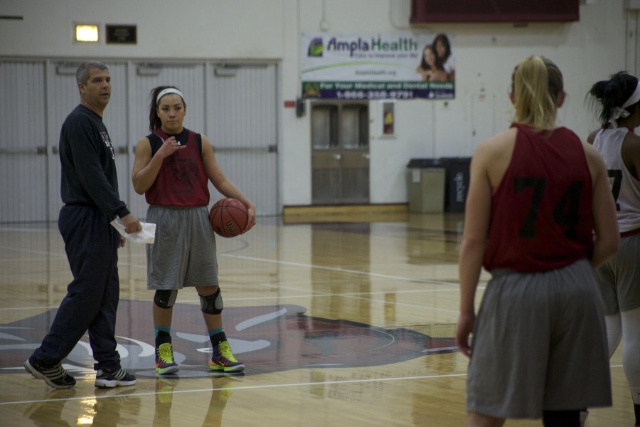 Chico State womens head coach, Brian Fogel, and freshman guard, Whitney Branham, go over plays during practice. Photo credit: John Domogma