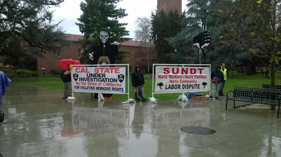 Union workers brave the elements while spreading the word about a CSU East Bay labor dispute Monday of finals week. Photo credit: Enrique Raymundo