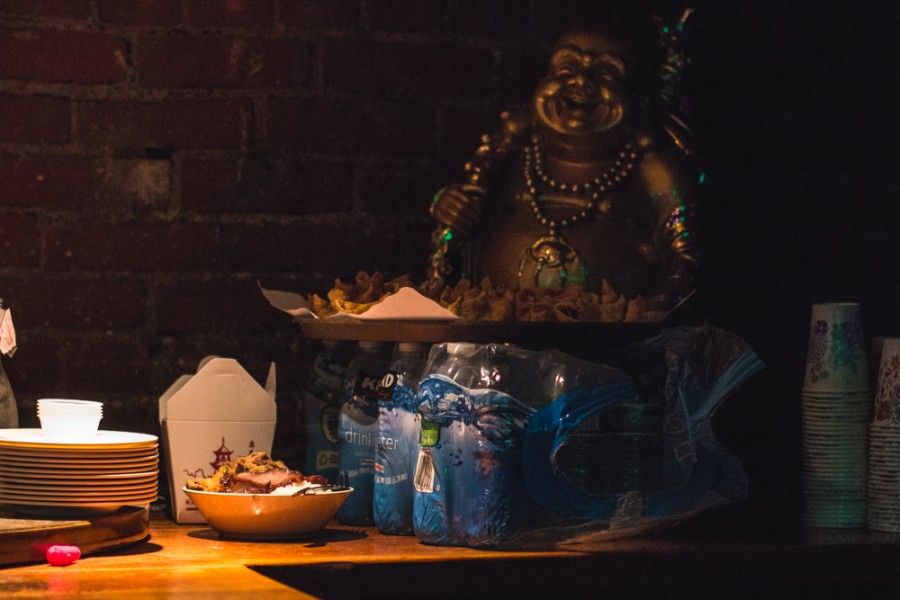 Chinese food with gold statue in background.