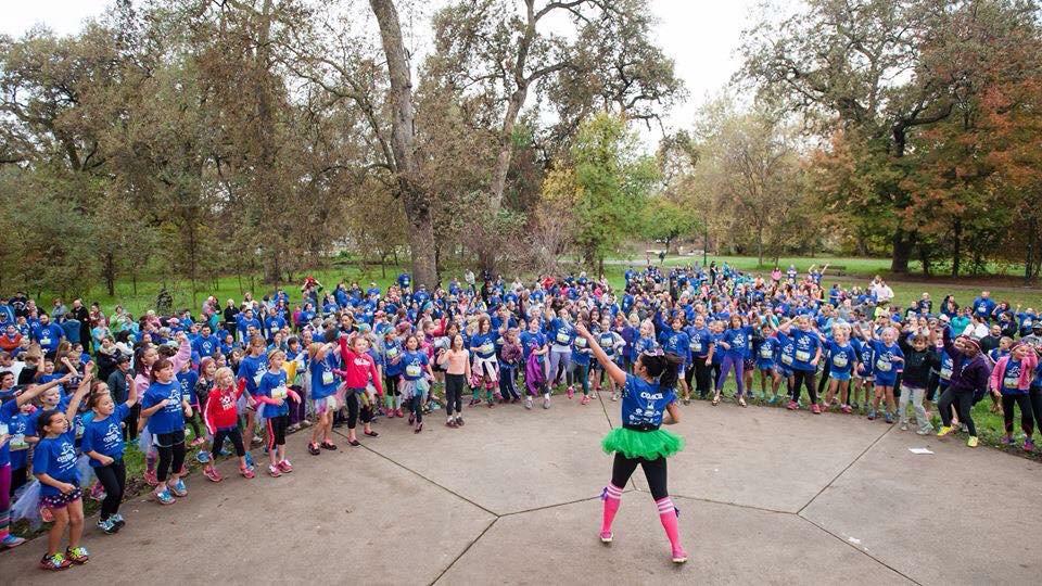 Brittany Kissinger, Chico State Alumn, warms up the crowd for Girls on the Run with her zumba dance moves.