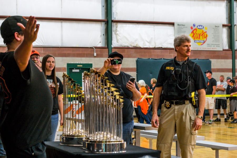 Retired Lieutenant George Laver helps the crowd flow through as hundreds of Butte County residents get pictures with the SF Giant's World Series trophies. The 3 trophies were on display on Saturday, Jan. 31, 2015 at the Arron Ray Clark Memorial Field House. Photo credit: Trevor Ryan
