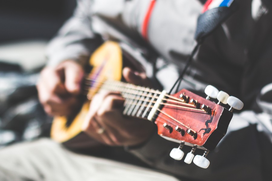 During a break between classes Chico State student Ira Salamon takes the opportunity to play a small travel guitar outside Creekside Coffee, Feb. 10, 2015.