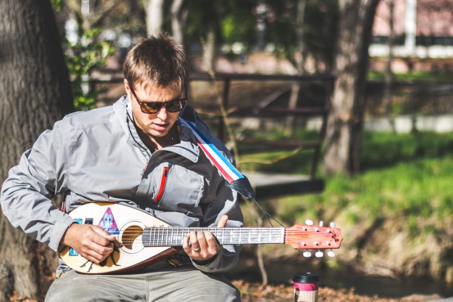 During a break between classes Chico State student Ira Salamon takes the opportunity to play a small travel guitar outside Creekside Coffee, Feb. 10, 2015.