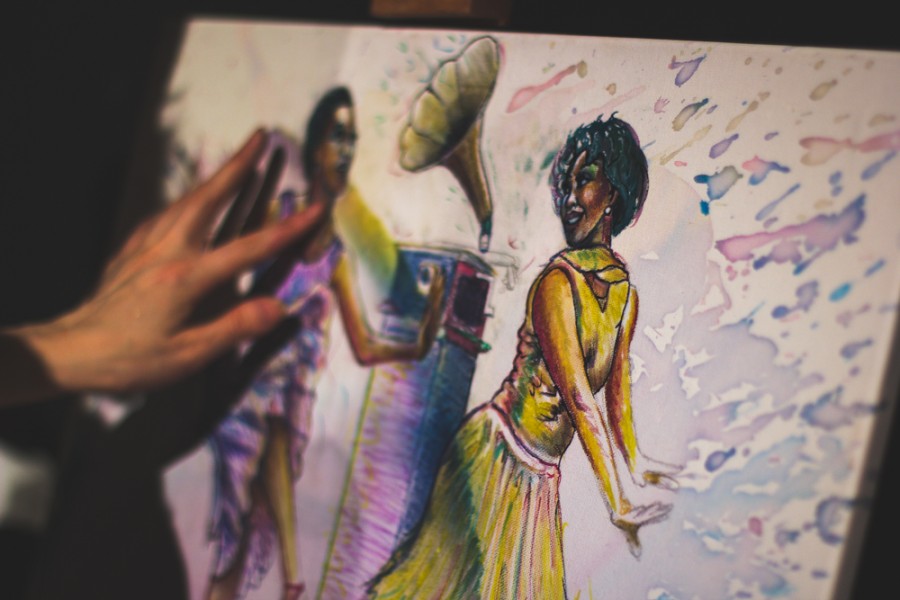 Artist Heather Bennett works on a piece where her artwork was being shown during the annual Rent Party, Feb. 12 2015. More of her work can be seen at facebook.com/candycougarART and at various locations locally. Photo credit Trevor Yale Ryan