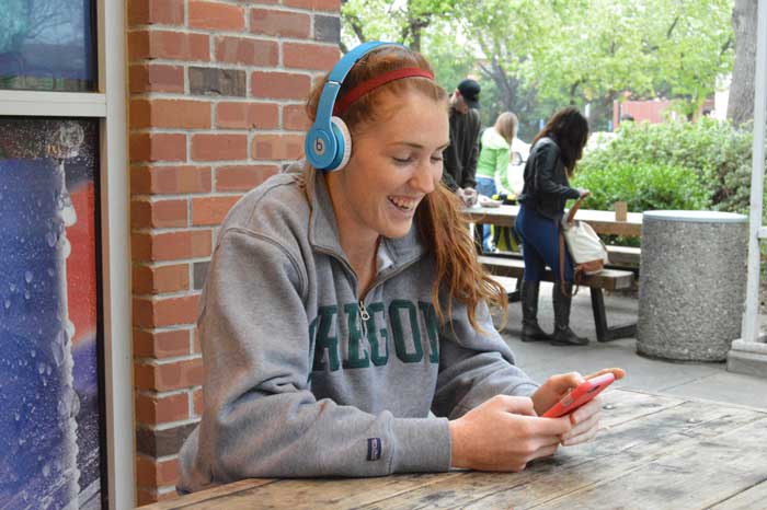 Brooke Bowen, forward on the womens basketball team, listens to her favorite song, Fight Night, outside of Butte Station. Photo credit: Caio Calado