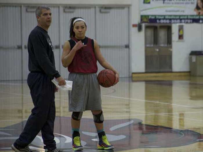 Chico State women’s head coach Brian Fogel and first-year guard Whitney Branham strategize during practice. Branham has started in all games this season and is tied for the most assists. Photo credit: John Domogma