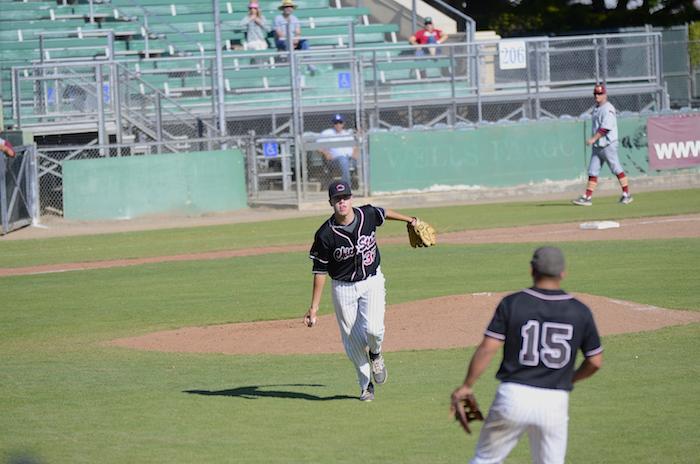 First year pitcher Hunter Haworth tosses the ball to senior Dylan Garcia to beat a Cal State Dominguez Hills batter from getting on base in a game on April 10. Photo credit: Ryan Pressey