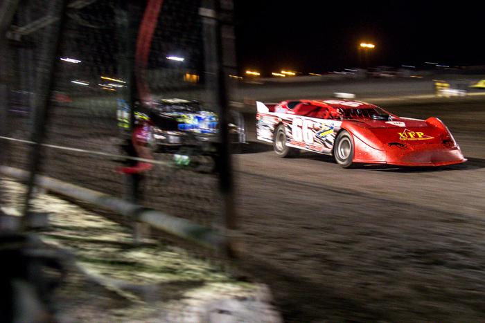 Two Limited Late Model cars go neck and neck across the line. Photo by Trevor Ryan