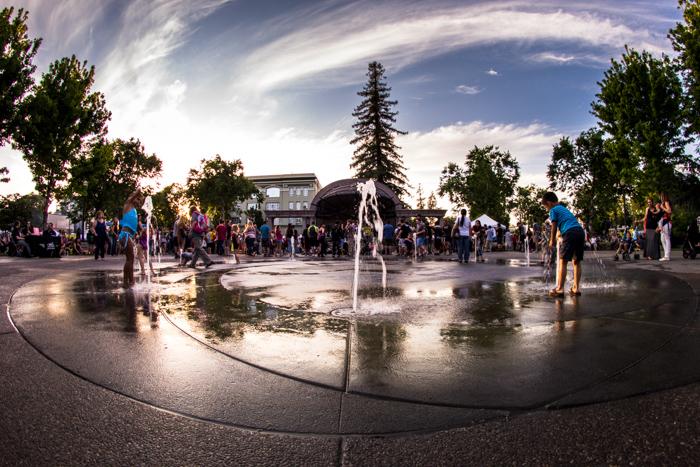 Kids catch some of the last sun of the day as they run through the fountains of Downtown Chicos City Plaza during the Farmers Market. Photo by Trevor Ryan