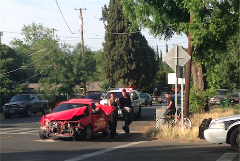 An officer speaks with the driver of the car that turned onto 8th street. Photo credit: Katherine Feaster