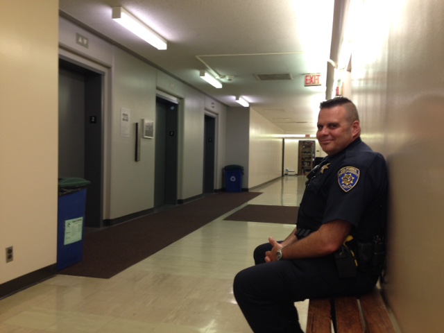 University Police officer, Lance Conlan, keeps watch on students stuck in Butte Hall elevators. Photo credit: Amanda Rhine