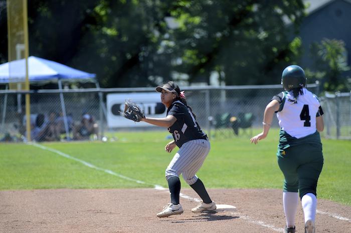 Junior first baseman Desiree Gonzalez tries to get out a runner on April 3 in a game against UC San Diego. Photo credit: Ryan Pressey