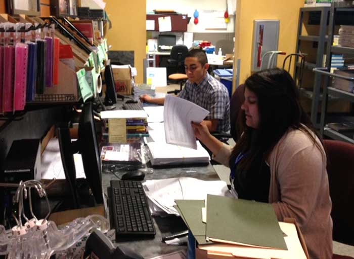Wildcat Store employees Ruben Ruiz, a first-year sociology major, and Victoria Diaz, a sophomore sociology major, get ready for the end-of-semester book return rush. Photo credit: Michael Arias