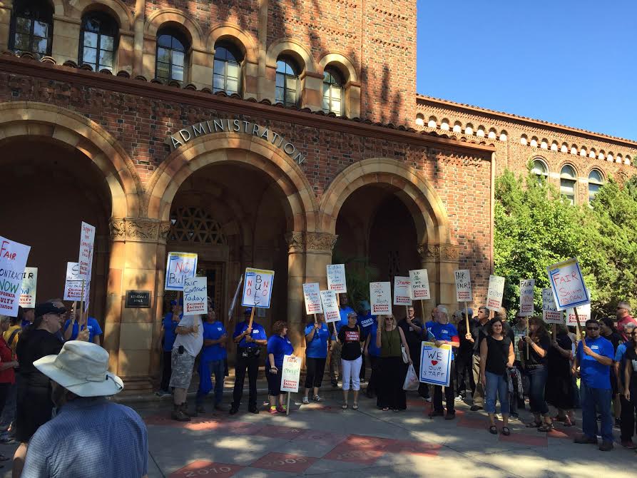 Rally members protest for change in front of Kendall Hall. Photo credit: Michael Catelli