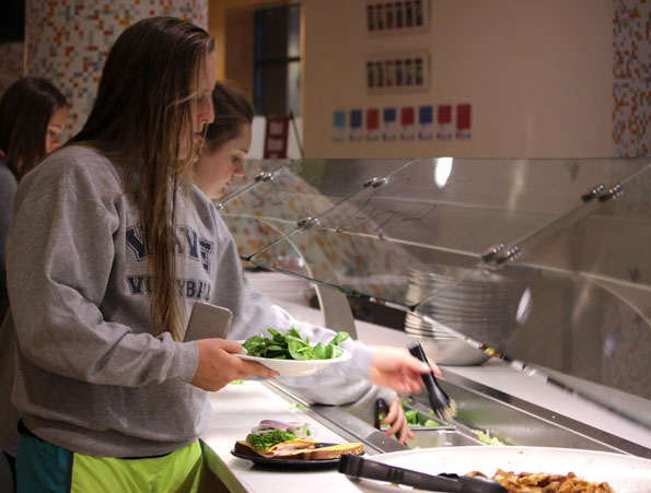 First-year animal science major, Delaney Friel, gets salad from the Sutter Dining Hall self-serve bar on Sunday. Photo credit: Christine Zuniga