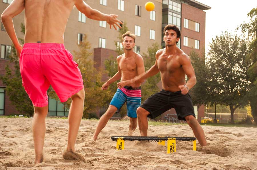 Preston Bies, Tom Whitt and Taylor Johnson in the middle of an intense Spikeball match on the volleyball court between Shasta and Lassen Halls. Photo credit: Sam Barker