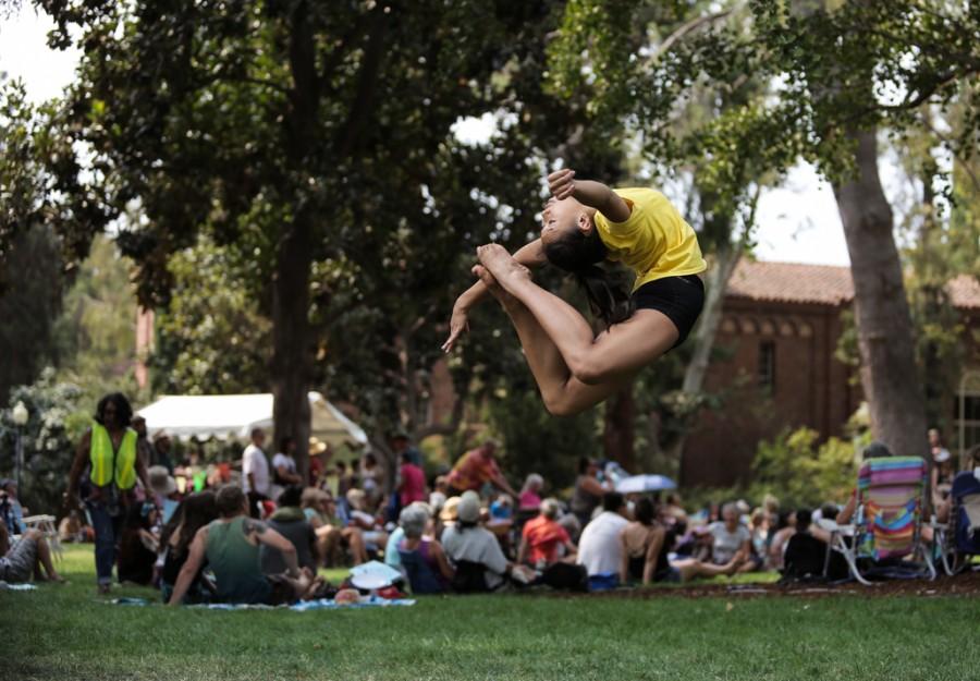 Kimly Lewis, 15, performs a ring flip in front of Kendall Hall during Chico World Music Festival. Photo credit: Emily Teague