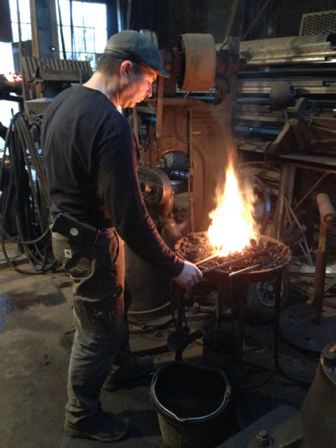 Dave+Richer%2C+owner+of+Earthern+Iron%2C+stokes+a+coal+forge.+Photo+credit%3A+Nathan+Graves